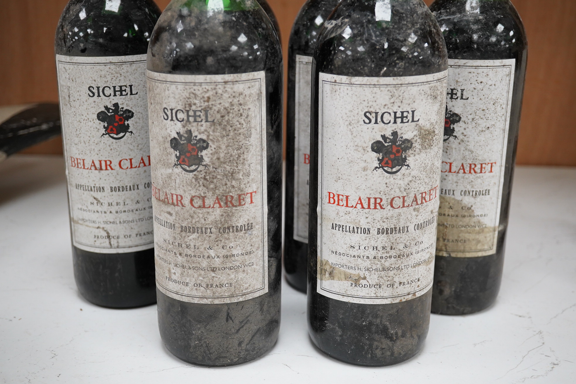 Six bottles of Sichel Belair Claret. Condition - dirty